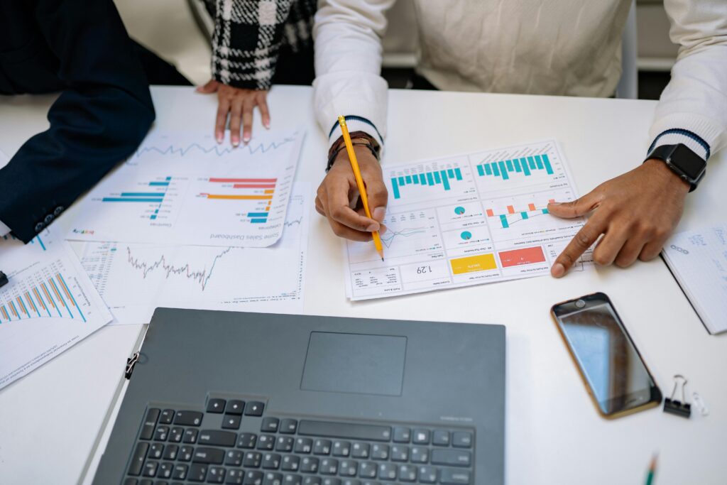pexels-photo-7691715-7691715 Team of professionals working on financial reports using charts and devices.